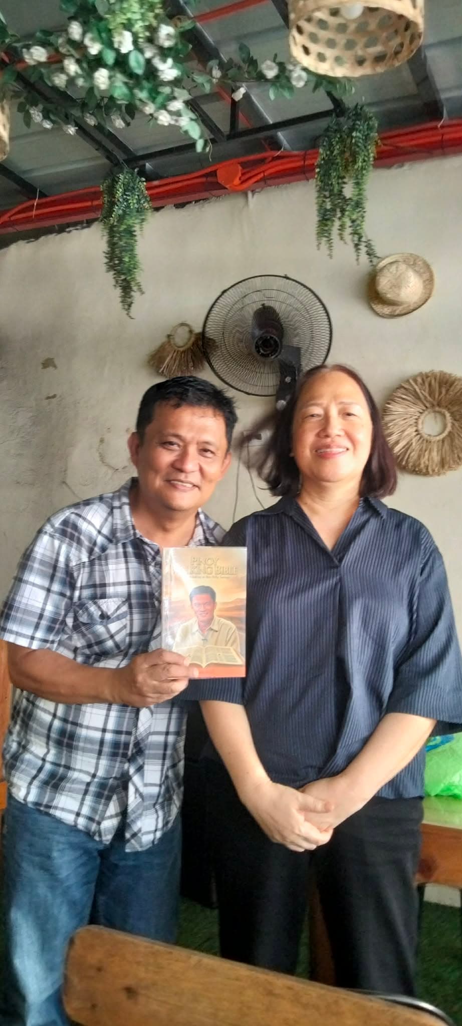 Wide view of fellowship around Pinoy Walking Bible distribution materials