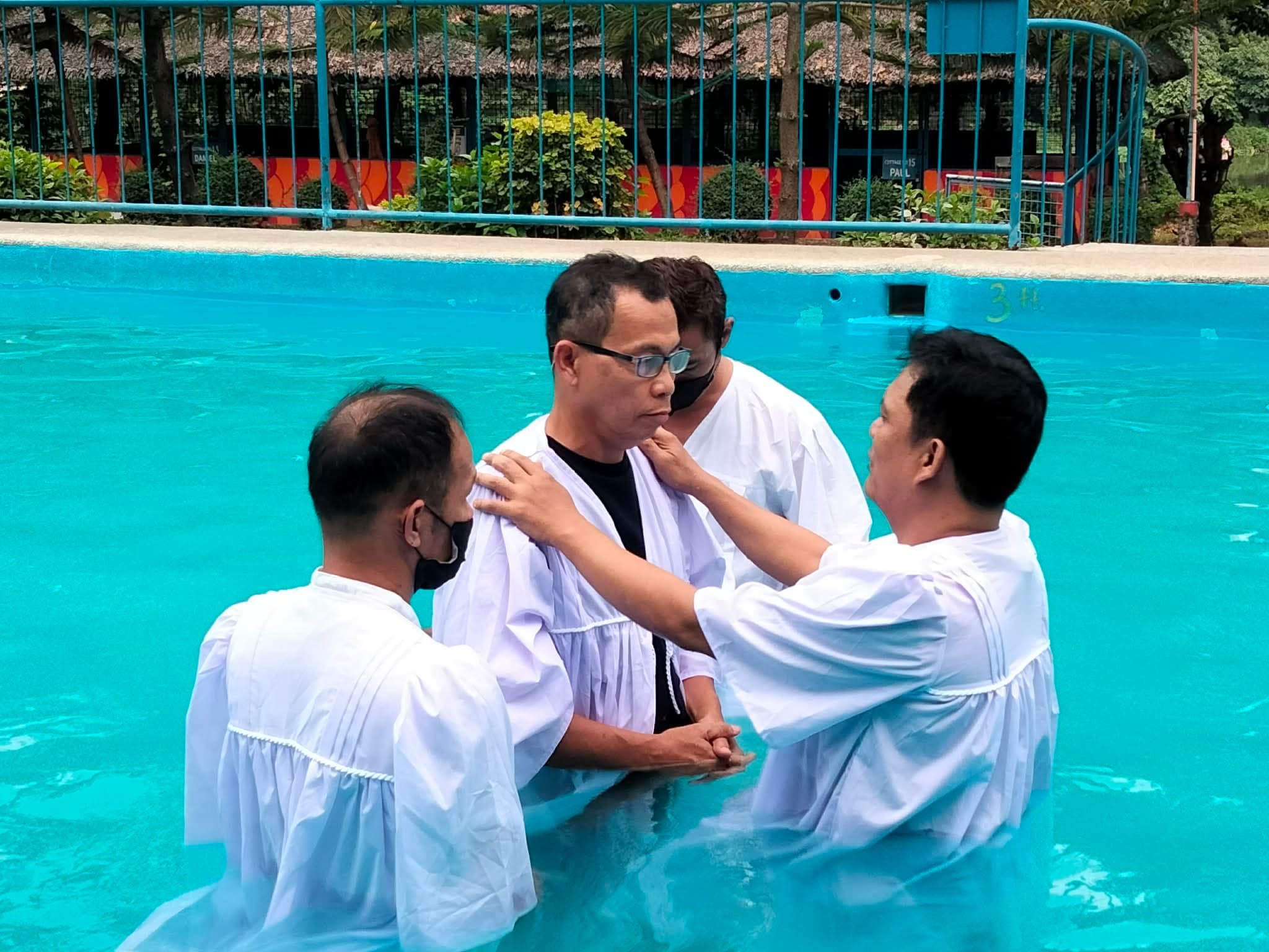 Baptism party rejoicing together at the poolside after the service